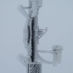 Weather mast covered with several inches of ice