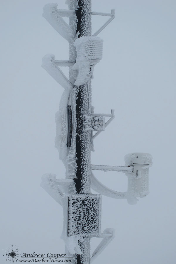 Weather mast covered with several inches of ice