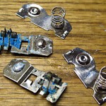 Damaged and replacement battery contacts