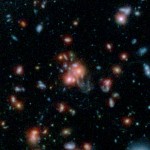 A massive cluster of galaxies, called SpARCS1049+56, can be seen in this multi-wavelength view from NASA's Hubble and Spitzer space telescopes. Credit:  NASA/STSCI/ESA/JPL-Caltech/McGill