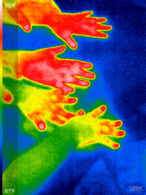 Thermal image of hands creating thermal handprints