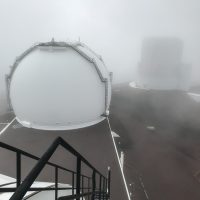 Fog wisps between the domes in this view from the top of Keck 2