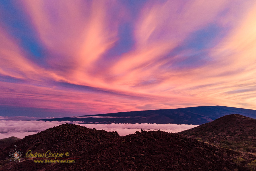 A colorful sunset lights the clouds over Mauna Loa