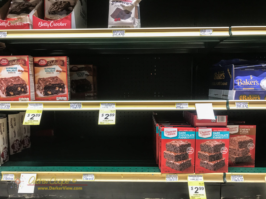 The brownie mix shelves with gaps of out-of-stock items
