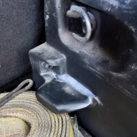 A damaged cargo bed support in a Jeep Compass