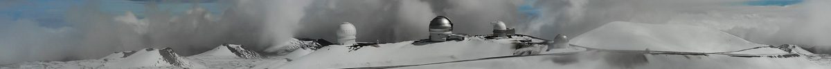 Observatories in the snow atop the summit of Mauna Kea
