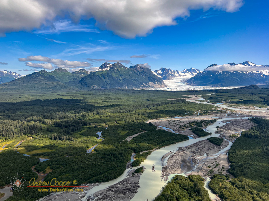 A muddy Sheridan River drains the lake in front of Sheridan Glacier