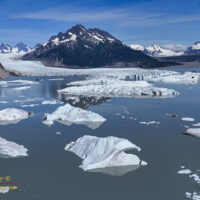 Icebergs scattered across the lake in front of Sheridan Glacier