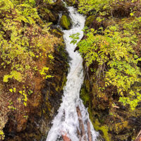 A small unnamed stream tumbles through the rock